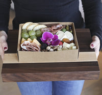 Thumbnail for A Man Holding Holiday Charcuterie Board Gift Boxes & Tin